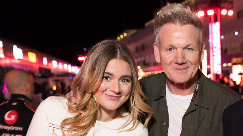 Gordon Ramsay smiling for camera with daughter Tilly at a brightly lit nighttime event