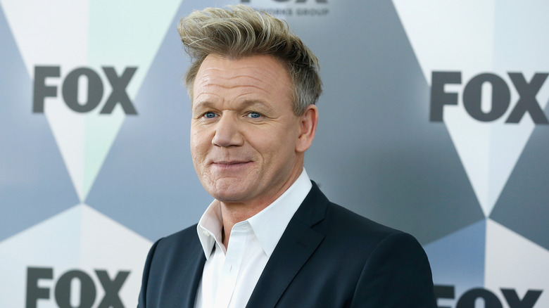 Gordon Ramsay smiling for cameras in suit at a Fox tv event