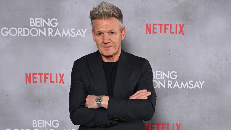 Gordon Ramsay stands with arms crossed and looks at camera at the premiere of his Netflix documentary "Being Gordon Ramsay"