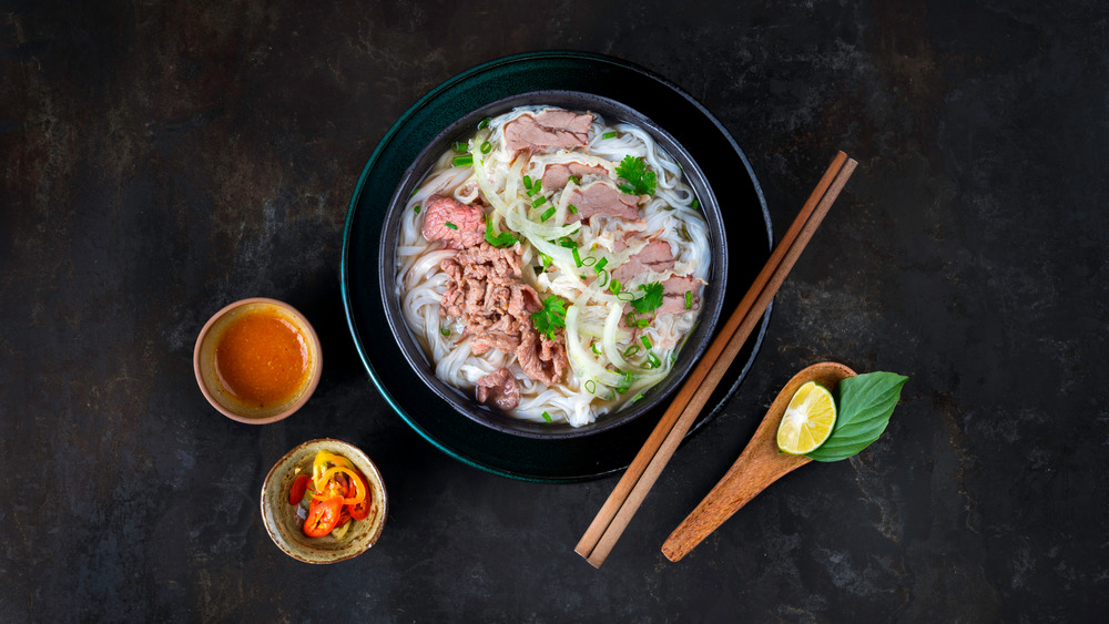 Bowl of pho on a black background