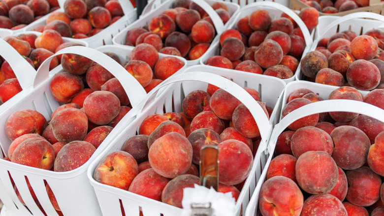 Baskets of peaches on table