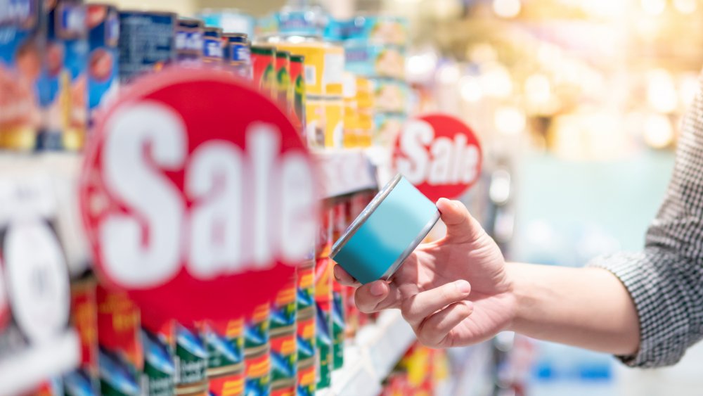 A generic image of a person buying canned food