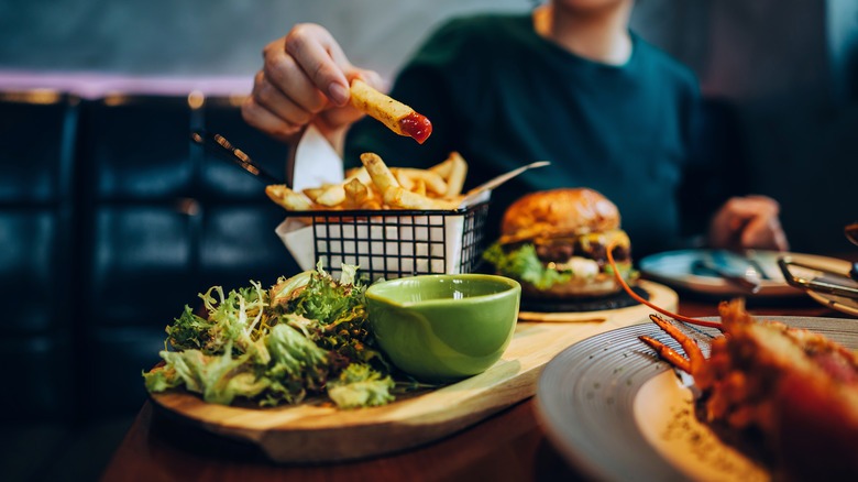Woman with a burger and fries