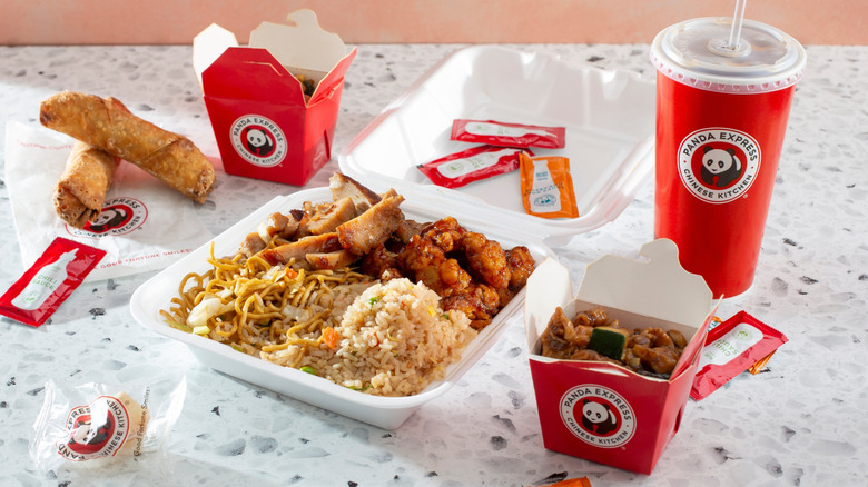 Assorted Panda Express foods, sides, and drink on table
