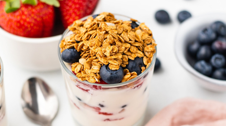 Yogurt parfait in jar topped with berries and granola