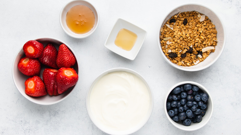 Berry breakfast parfait ingredients laid out