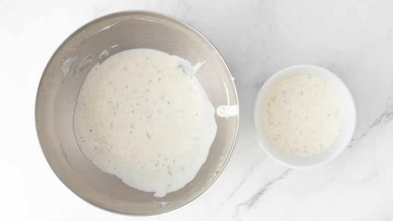 Ranch dressing in large mixing bowl and in white ramekin