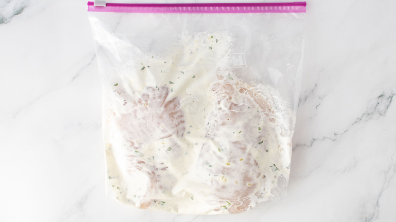 Chicken breasts and ranch dressing in zip-top baggie