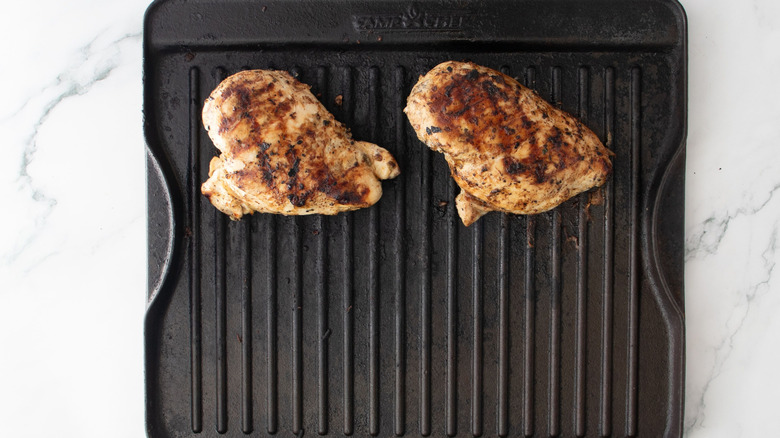 Chicken breasts with grill marks on grill pan