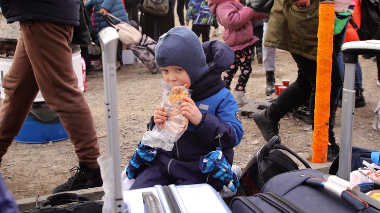 Ukrainian child refugee eating food