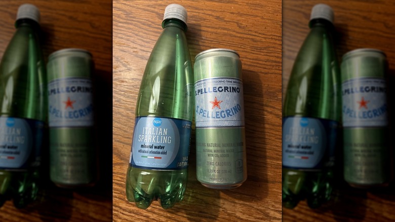 Bottle of PurAqua Italian sparkling mineral water next to a can of Sanpellegrino on a wooden surface