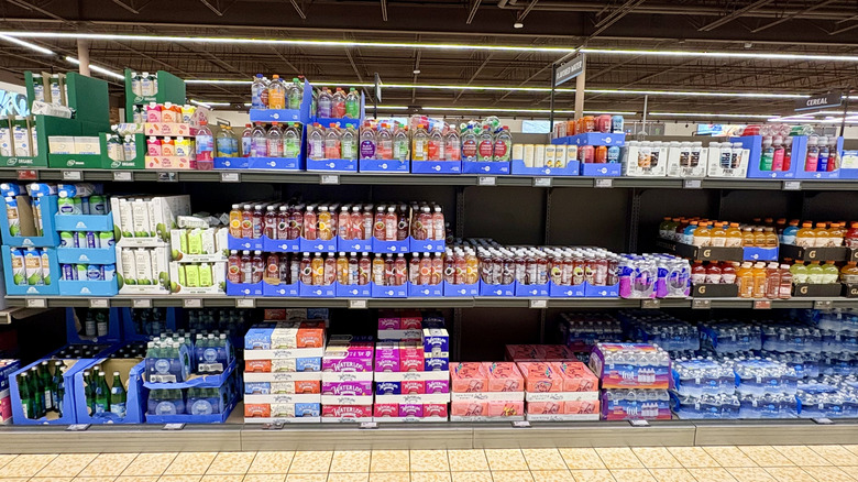 Bottled water and other beverages line an aisle inside Aldi