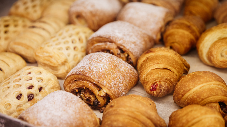 Various baked goods being removed from oven