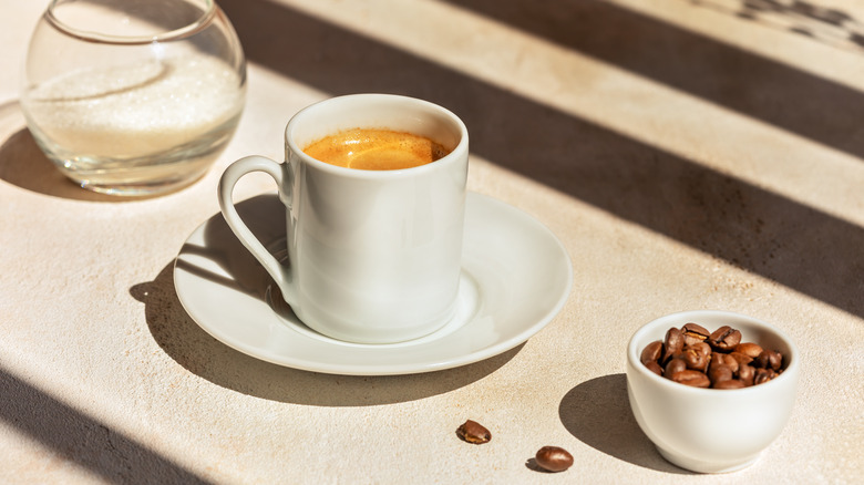 Espresso and bowl of coffee beans