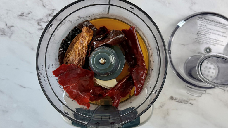 Various chiles and liquid in food processor