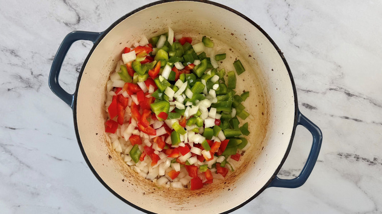 Diced onion and bell peppers in pot