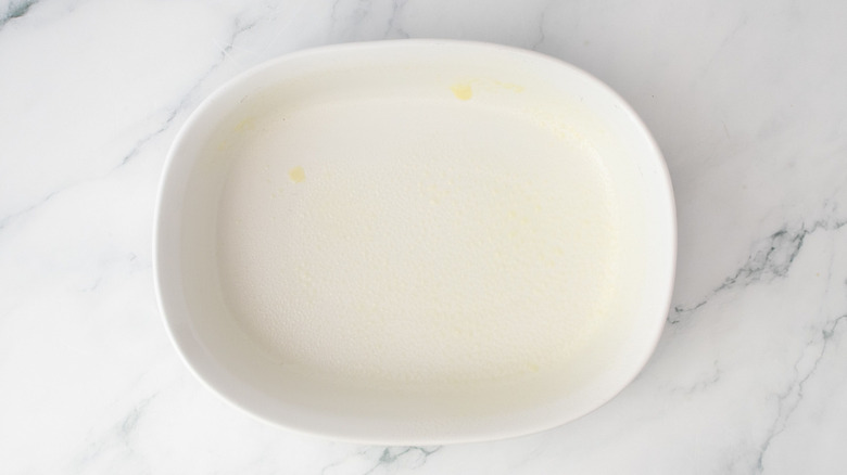 Greased casserole dish on countertop