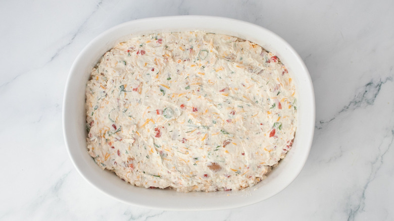 Pimento chicken bacon ranch dip spread out in casserole dish