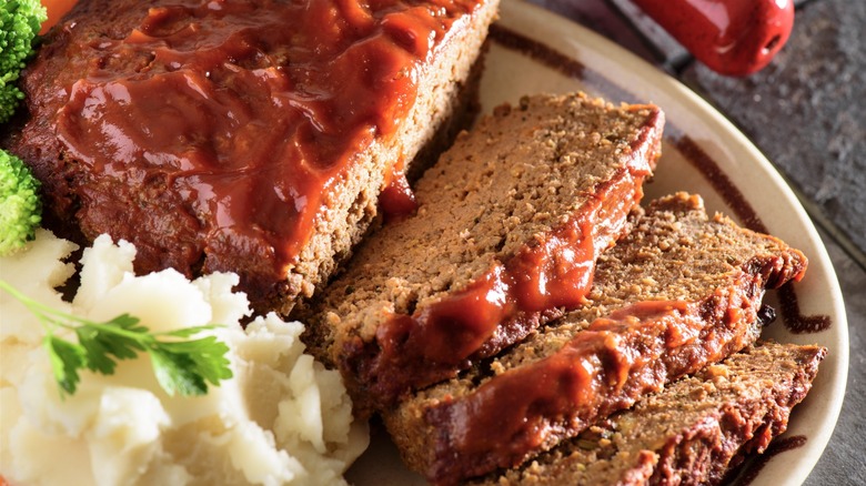 Sliced meatloaf on a plate with mashed potatoes