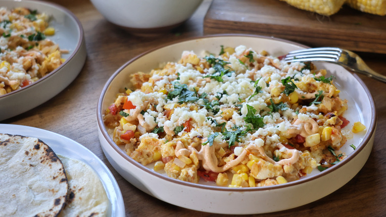Elote breakfast scramble in bowl with cotija cheese and cilantro