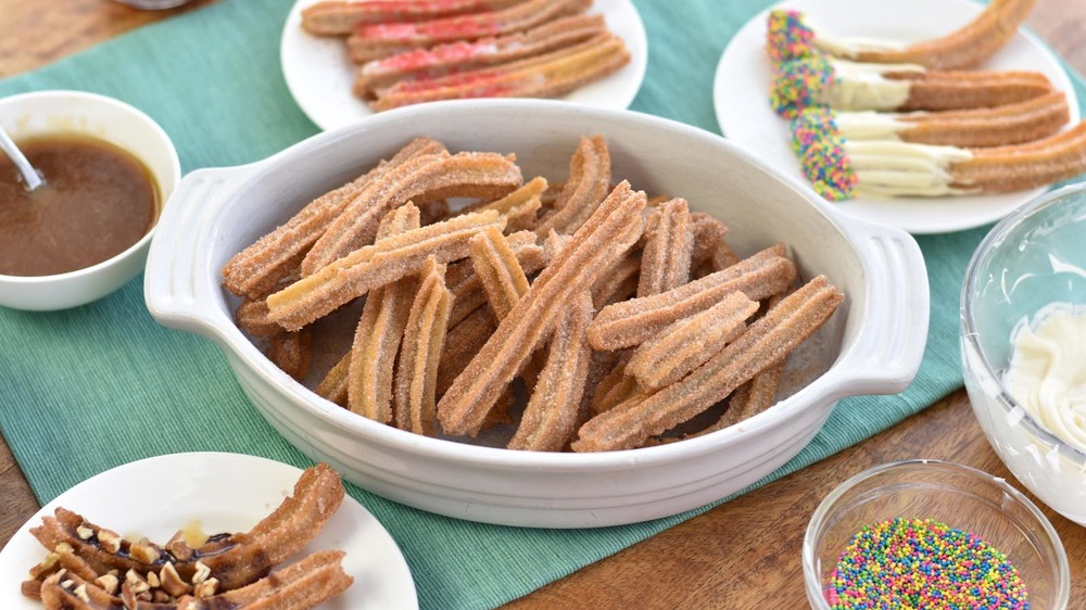 plates of churros with sprinkles