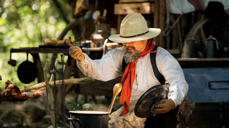 Cowboy cooking outdoors