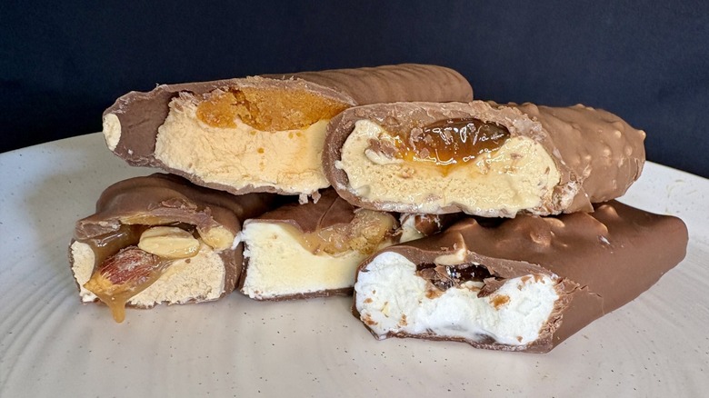 Assorted halved ice cream candy bars on plate.