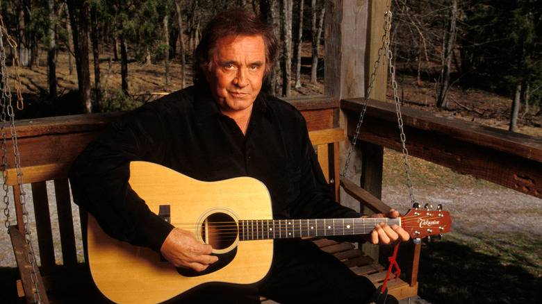Johnny Cash on porch swing with guitar