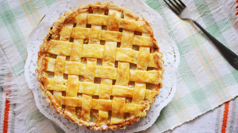 Pineapple pie on plate with fork nearby