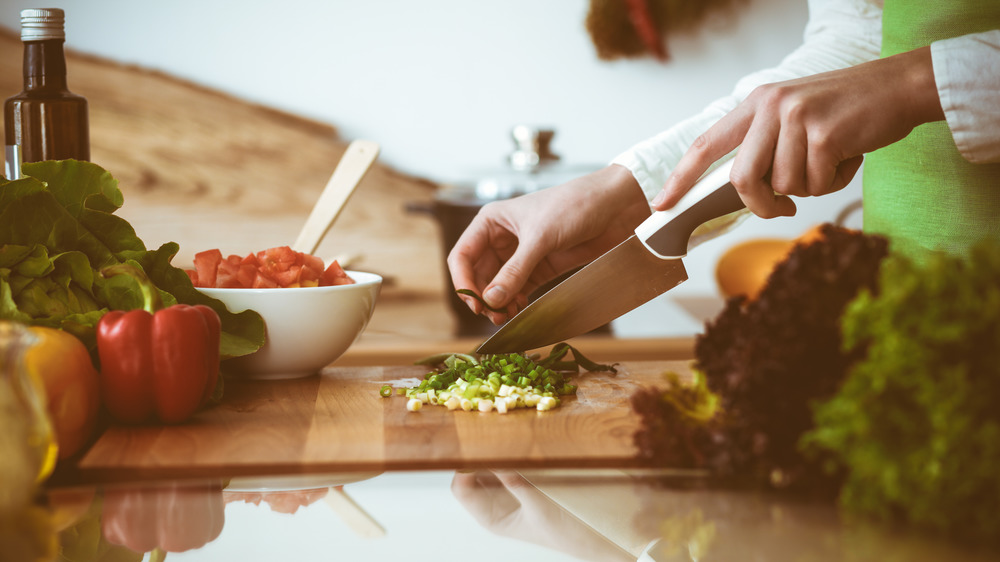 Person cutting vegetables on a cutting board