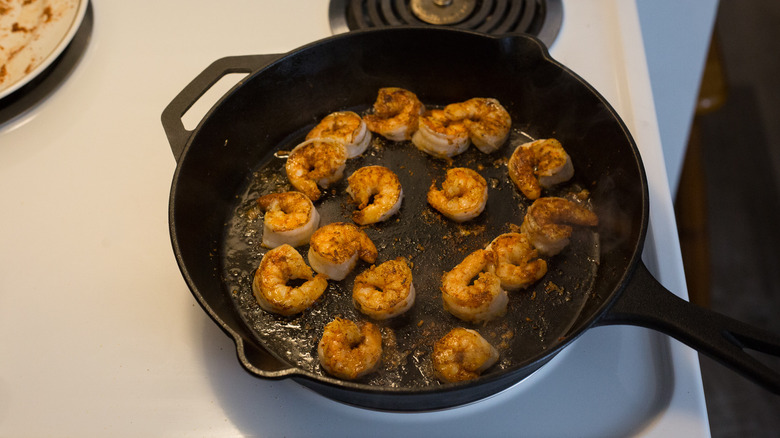 shrimp cooking in iron pan