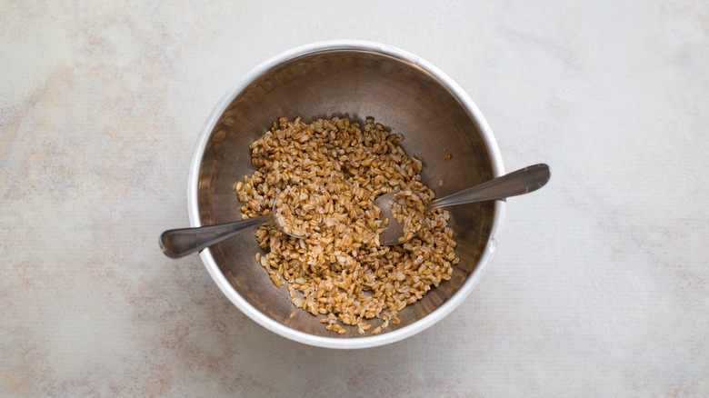 cooked farro in mixing bowl