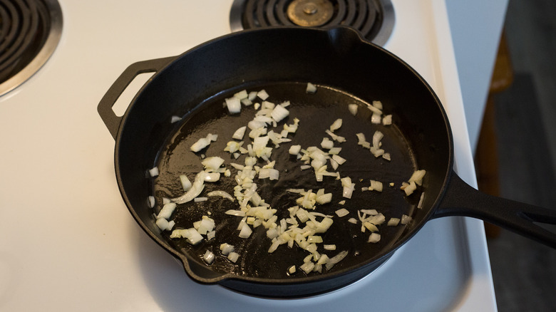 onion cooking in iron pan