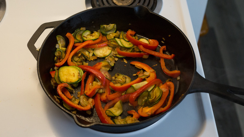 vegetables cooking in iron pan