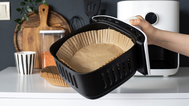 Disposable container in air fryer basket