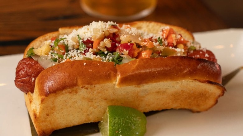 Camacho Garage Mexican hot dog in brioche bun with lime