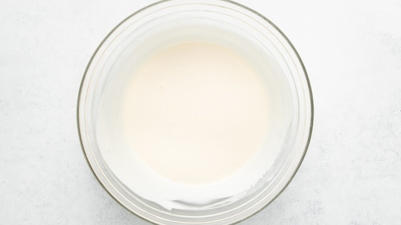 Sour cream mixture in glass mixing bowl