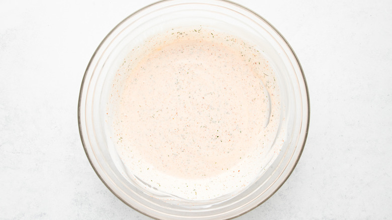 Copycat Popeyes blackened ranch sauce in glass mixing bowl