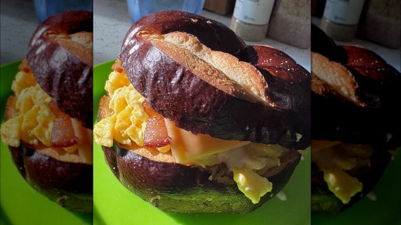 An egg, bacon, and American cheese sandwich with pretzel bagel buns.
