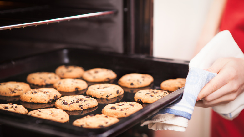 Person pulling cookies out of the oven