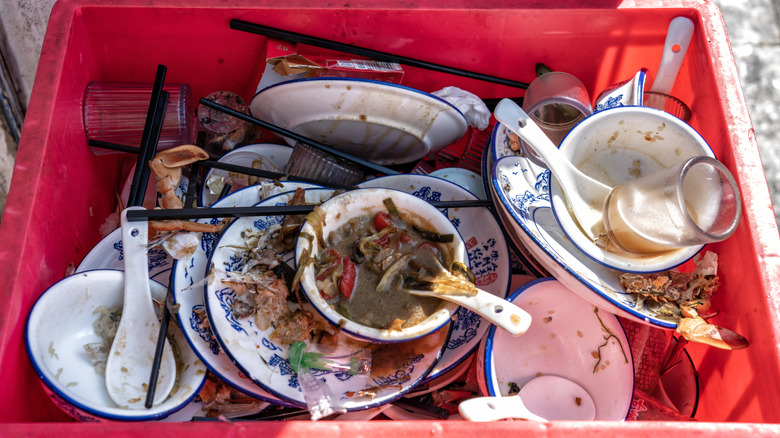 Dishes of food thrown away outside a restaurant