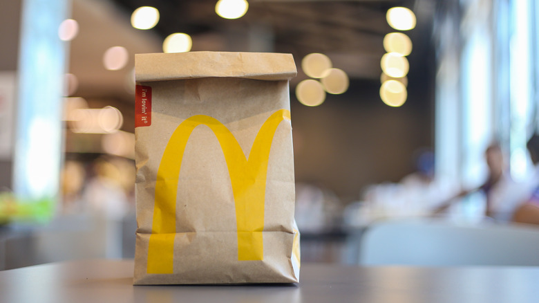 McDonald's takeout bag on table.