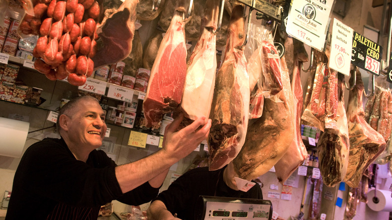 Iberian ham hanging in market