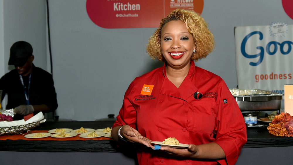 Chef Huda Mu'min holding plate