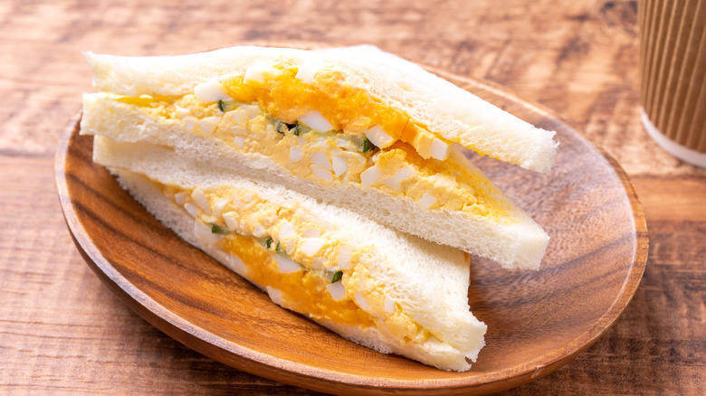 An egg salad sandwich on white bread