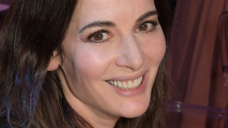 Nigella Lawson smiling with hair down in a black top