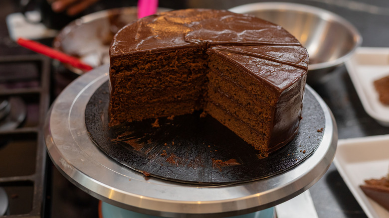 Chocolate cake on stand by oven