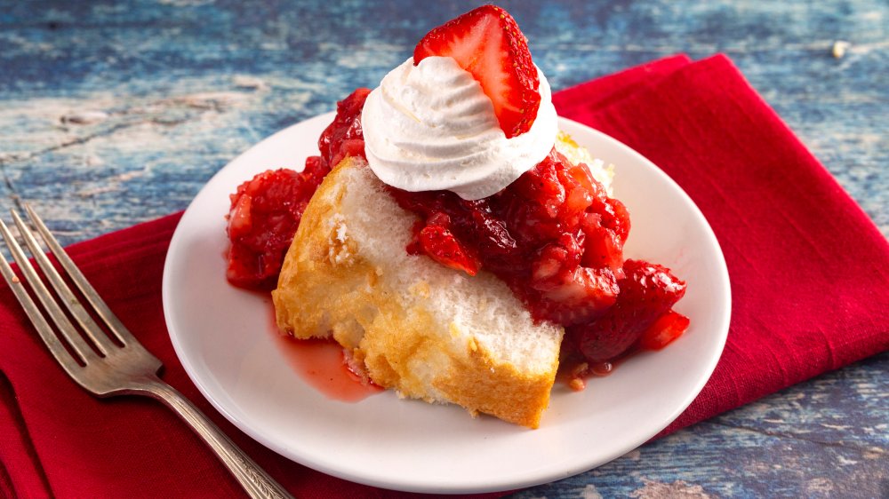 Strawberry shortcake with whipped cream and red napkin