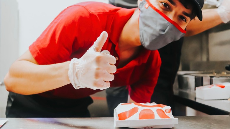 Chick-fil-A worker posing with sandwich