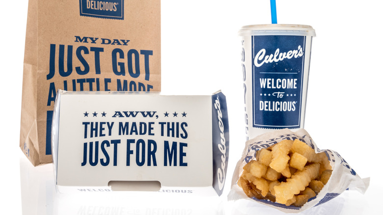 Culver's bag, cardboard box, soda cup with lid & straw, and paper bag of french fries